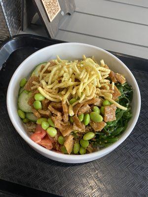 My custom veggie poke bowl with edamame, seaweed salad, rice, fried tofu, crispy onion, pickled ginger slices, cukes