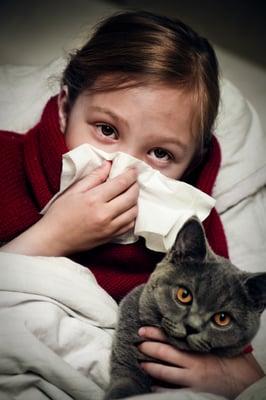 A girl, who is allergic to her cat