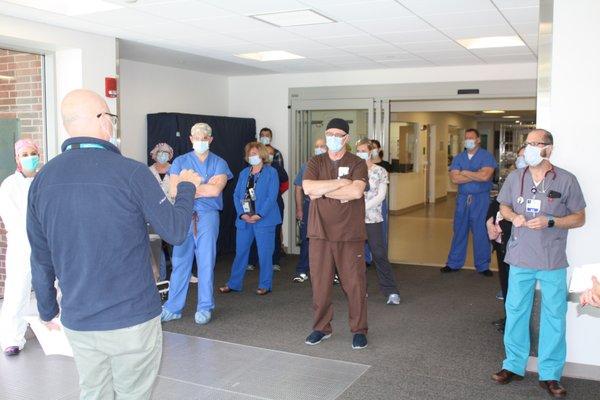 In the daily huddle, emergency room staff prepares for the work ahead.