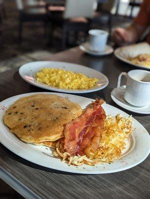 Pancakes and bacon with a side of eggs