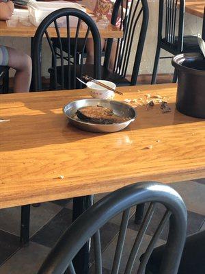 Chef eating and spitting bones on customer table