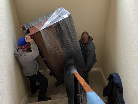 Will and Eli getting a dresser down stairs