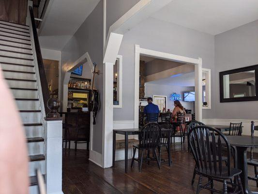 Dining area and bar, with stairs to rooms to rent on the left