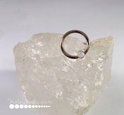 Rose gold captive bead ring with genuine AAA White Opal.