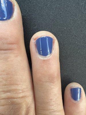 Terrible cuticle trim and uneven polish.