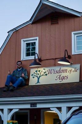 Charlie on the roof after having hung our sign at our new location we moved to in February 2024, at 1618 Hopmeadow St, Simsbury, CT 06070