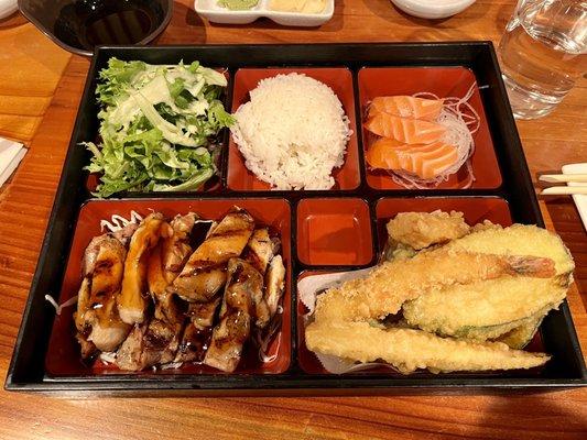 Bento box combo with chicken teriyaki, tempura, and salmon sashimi