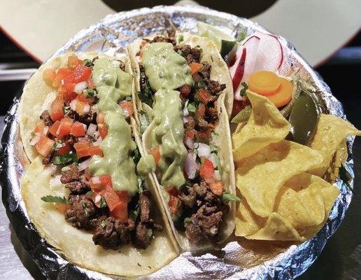 Super steak tacos! Melted cheese, Carne asada, pico de Gallo, cilantro, onions, lime jalapeños and radish, chips!