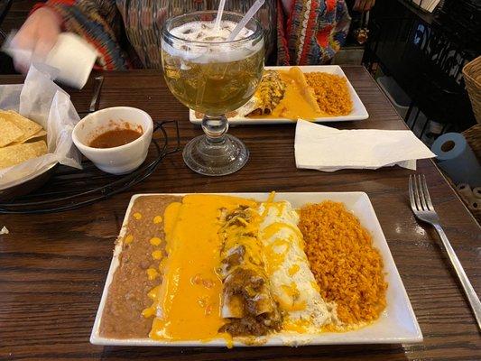 Enchiladas beef with chili con carne, chicken with sour cream and cheese with chili con queso