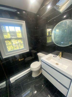 Sleek redesign. Modern, black marble bathroom