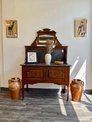 A 62" high antique sideboard with mirror and marble top. For sale at Evolution Home.