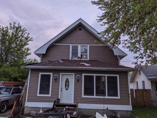 Enclosed the porch completely and installing a new roof. Also painted the home to match the new siding.