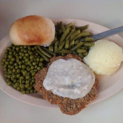 Chuck wagon steak, gravy, mashed potatoes, green beans, English peas, roll and tea $7.50 (5-5-16 price is $8.00)