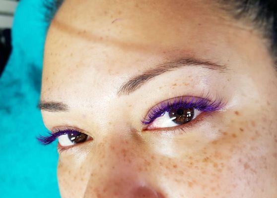 We do colored lashes too! Purple lashes enhance brown eyes