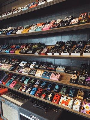 Massive wall of guitar pedals to choose from.