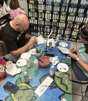 Guests painting at our turtle table in front of the paint bar.