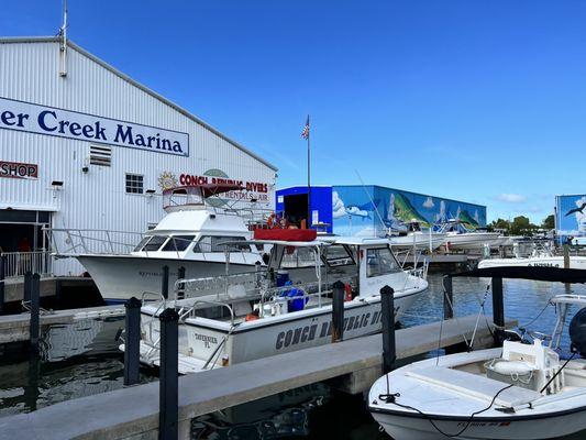 2 boats docked directly in front of the dive shop.