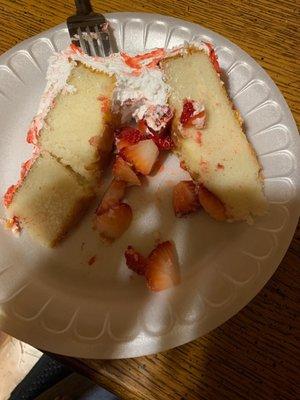 Cake with no glaze in the middle and strawberry falling out