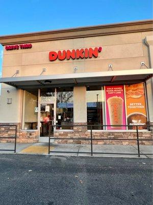 The Exterior of the shop nicknamed The Big Bite Dunkin' Donuts because of its unique 1/2 Donut sign in Bakersfield CA