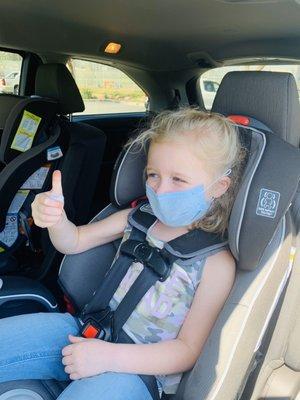 Daughter holding the bead that the doctor removed for her, while giving a thumbs up!