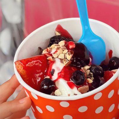 So delicious! Our "Classic Tart" frozen yogurt, with berries and diced nuts, smothered in strawberry sauce.