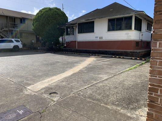 Customer parking is on the Kilani Avenue side of our building in front of this  house on our property.