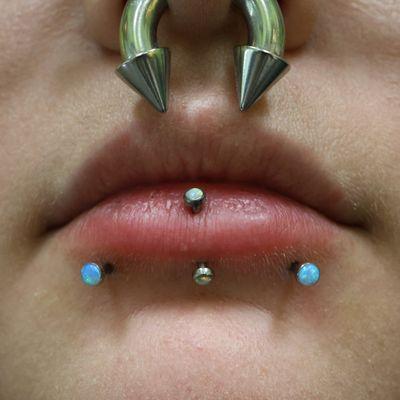 Fresh snake bite lip piercings with light blue opals!