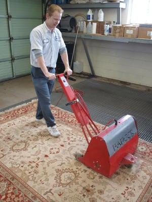 Rugs are vacuumed and "dusted" to remove dry particle soil prior to cleaning.