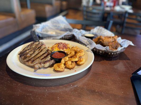 Steak and shrimp (foreground) with order of buffalo wings + extra sauce