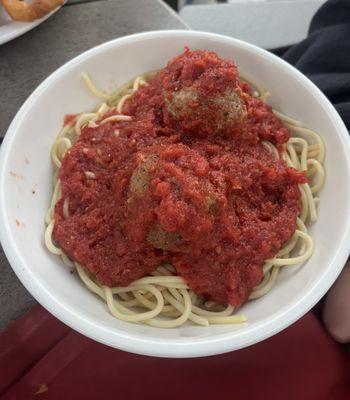 Kids, spaghetti and meatballs with marinara sauce