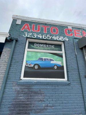 When the garage doors are open you can see  from the sidewalk the Inside of the M & M Auto Center on the garage wall the Grease Wall Mural