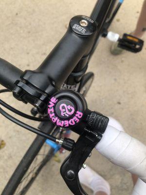 A bicycle handlebar Bell that is sporting the name of the company and their insignia!