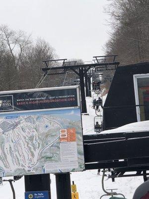 The lift on the left is closed while there is a big line of people waiting.