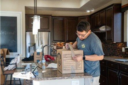 Josh working hard packing up a kitchen making  sure our customers items will travel safely in transit!