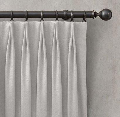 Double tack pleat installed on decorative rod with rings.