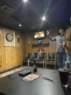 Darts! And the room has a long booth with tables so you can watch your peeps throw.