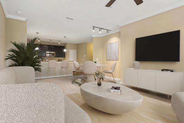 Open-concept, carpeted living room with plenty of space for furniture, a ceiling fan and view of kitchen area at Lantower Cypress Creek.