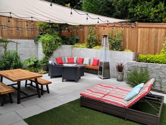 Concrete Paver Patio and Block Retaining Wall Create Ample Outdoor Seating.