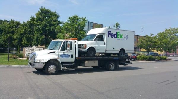 Towing FedEx delivery truck in for repair