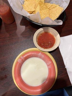 Cheese dip and salsa with chips.