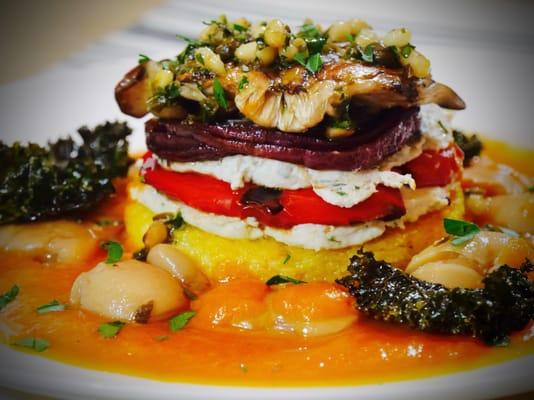 Polenta and Vegetable Napoleon Stack with Herbed Cashew Cream. Maitake Mushroom and Tomato-Saffron Coulis, Butter Beans and Roasted Kale