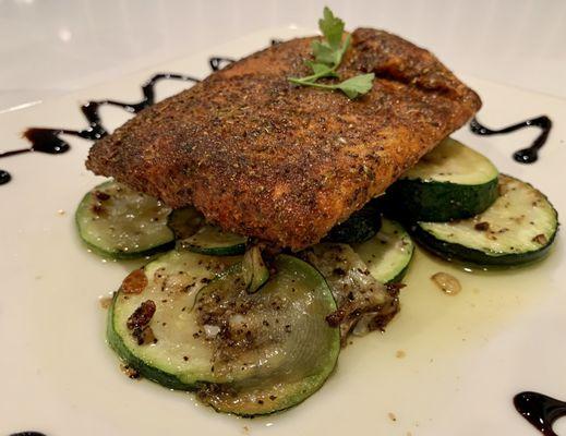 Grilled salmon blackened with sautéed zucchini