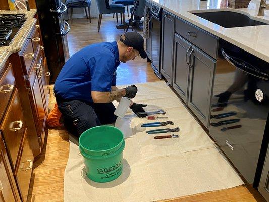 Pat Plumbing, Heating and Air Technician disinfecting his plumbing tools.