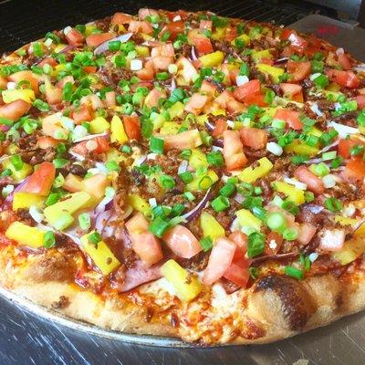 Maui Pizza: Spicy Red Sauce, Mozzarella Cheese, Smoked Ham, Smoked Crispy Bacon, Juicy Pineapple Red Onions, Green Onion & Fresh Tomatoes