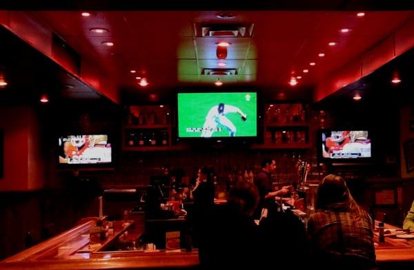 Three TVs installed in restaurant / bar.