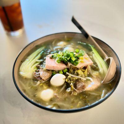 It just says mustard greens noodle soup on the menu, but it's so much more with fish balls, beef slices, quail eggs and slices of SPAM.