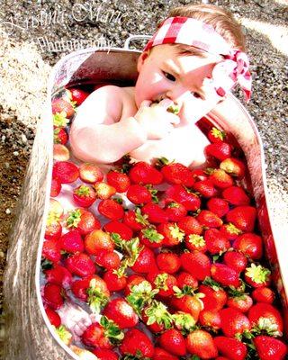 Such a sweet girl tasting strawberries for the first time