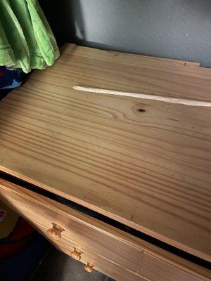 Three-foot length of wood sheared off the back of the dresser. How the heck do you do that??