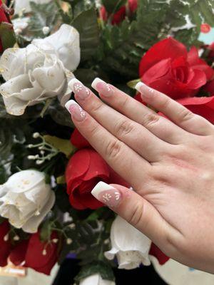 Custom French tip design with flower detail