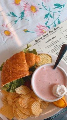 Half chicken salad sandwich and cup of strawberry gazpacho